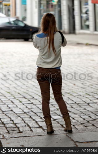 Rear view of a woman standing on a street, Bergen, Norway