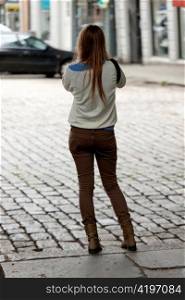 Rear view of a woman standing on a street, Bergen, Norway