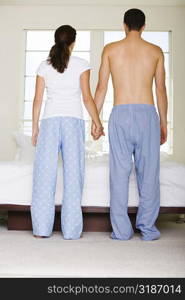 Rear view of a young couple holding hands