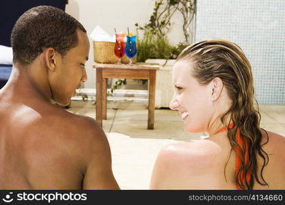 Rear view of a young couple looking at each other