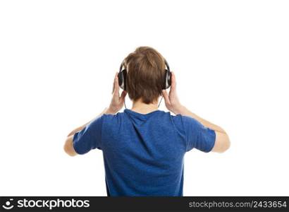 Rear view of a young man listening music with headphones, isolated on white background