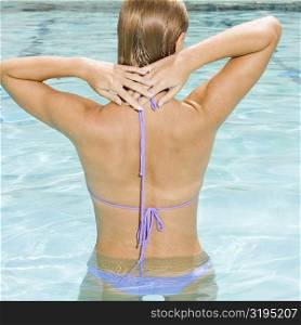 Rear view of a young woman in a swimming pool