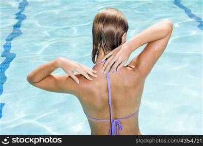 Rear view of a young woman in a swimming pool