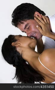 Rear view of a young woman kissing a mid adult man