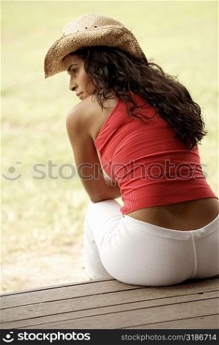 Rear view of a young woman looking sideways