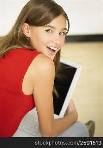 Rear view of a young woman using a laptop