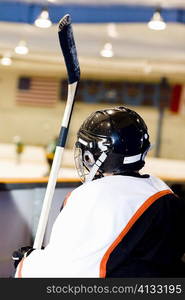 Rear view of an ice hockey player near an ice rink