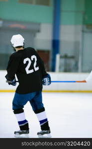 Rear view of an ice hockey player playing ice hockey