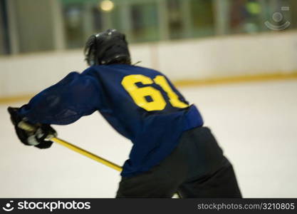 Rear view of an ice hockey player playing ice hockey