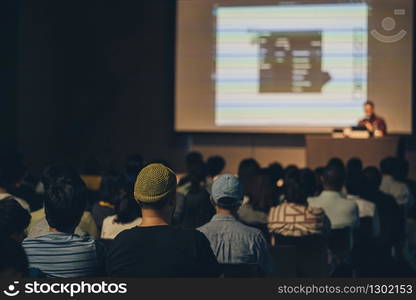 Rear view of Asian audience joining and listening speaker talking on the stage in the seminar meeting room or conference hall, education and workshop, associate and startup business concept