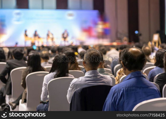 Rear view of Audience listening Speakers on the stage in the conference hall or seminar meeting, business and education about investment concept