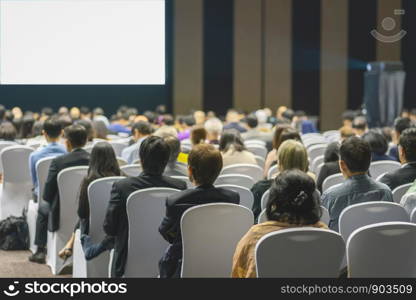 Rear view of Audience listening Speakers on the stage in the conference hall or seminar meeting, business and education about investment concept