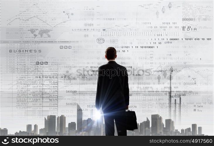 Rear view of businessman looking at business marketing strategy. Graphics and business strategy