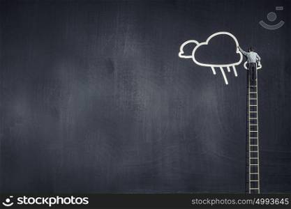 Rear view of businessman standing on ladder and reaching cloud. Cloud computing