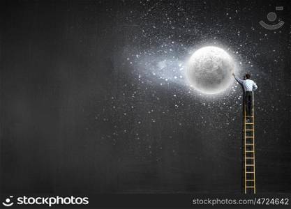 Rear view of businessman standing on top of ladder. Reaching moon