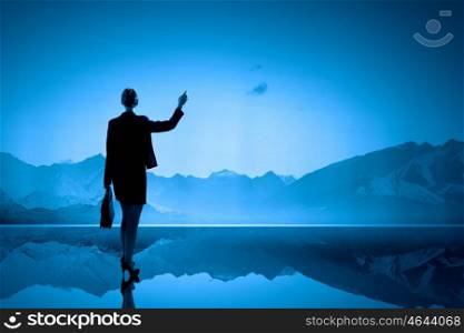 Rear view of businesswoman looking at picturesque nature landscape. Minute of isolation
