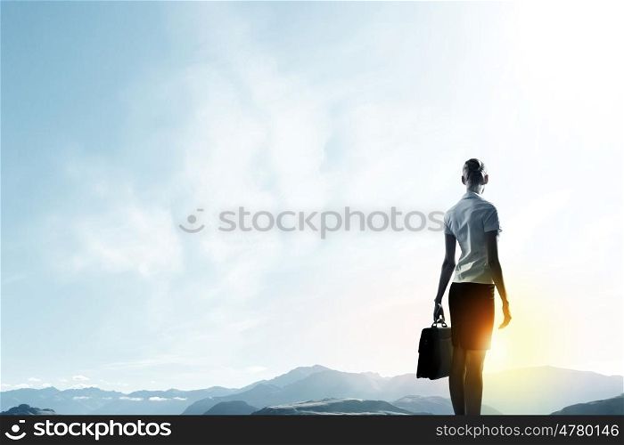 Rear view of businesswoman looking at sunset. New day