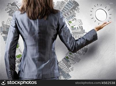 Rear view of businesswoman. Rear view of businesswoman and sketches at background