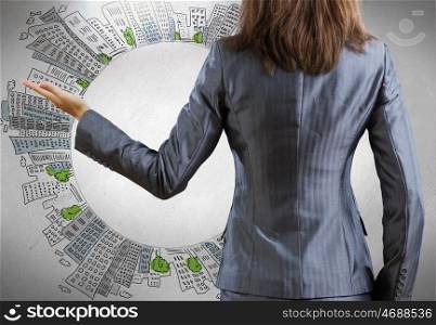 Rear view of businesswoman. Rear view of businesswoman and sketches at background
