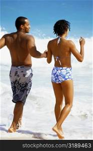 Rear view of couple in swimsuit, Horse-shoe Bay beach, Bermuda