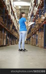 Rear View Of Female Worker In Distribution Warehouse
