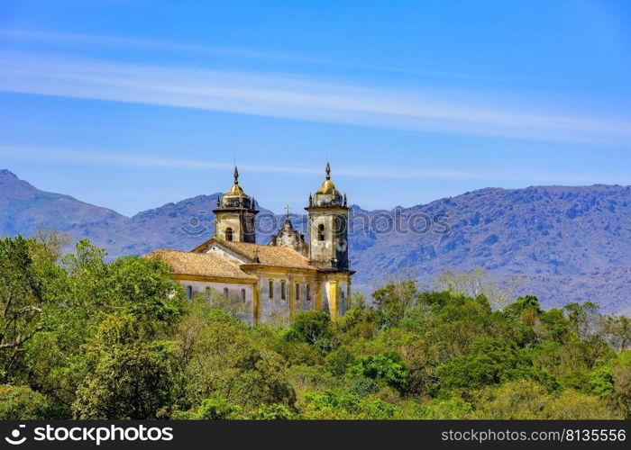 Rear view of historic church in baroque and colonial style from the 18th century amid the hills and vegetation of the city Ouro Preto in Minas Gerais, Brazil. Rear view of historic church in baroque and colonial style from the 18th century amid the hills and vegetation