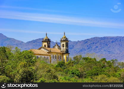 Rear view of historic church in baroque and colonial style from the 18th century amid the hills and vegetation of the city Ouro Preto in Minas Gerais, Brazil. Rear view of historic church in baroque and colonial style from the 18th century amid the hills and vegetation