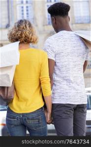 rear view of multi ethnic couple out shopping