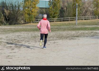 Rear View Of Senior Man Jogging At Park