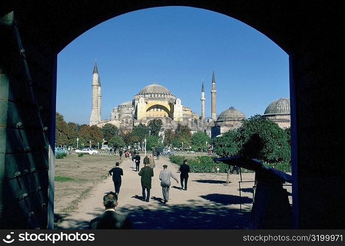 Rear view of tourist walking towards a mosque, Blue Mosque, Istanbul, Turkey