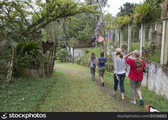 Rear view of tourists walking in a farm, Finca El Cisne, Honduras