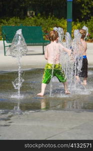 Rear view of two boys in a fountain