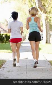 Rear View Of Two Female Runners On Suburban Street