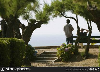 Rear view of two men in a garden, St. Martin, Biarritz, France
