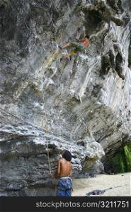 Rear view of two mountaineers rock climbing, Phi Phi Islands, Thailand