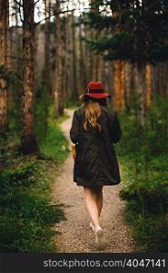 Rear view of woman walking in forest, Rocky Mountain National Park, Colorado, USA