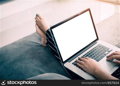 Rear view of women in a living room and laptop blank screen.