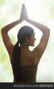 Rear view of young woman meditating