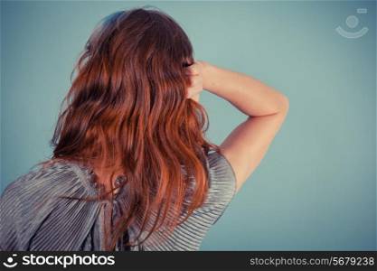 Rear view of young woman touching her hair
