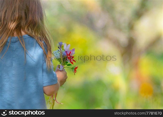 Rear View on a Cute Little Kid with Bouquet of Wildflowers. Having Fun on Beautiful Floral Meadow. Enjoying Fresh Spring Nature.. Happy Child on the Floral Field