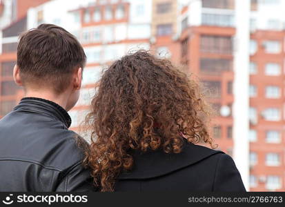 rear view on young pair looking at building