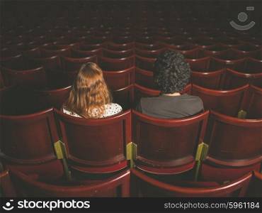 Rear view shot of a young couple sitting in a movie theater