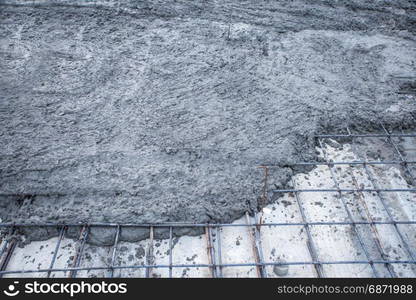 rebar grids with wet cement in concrete floor pouring process