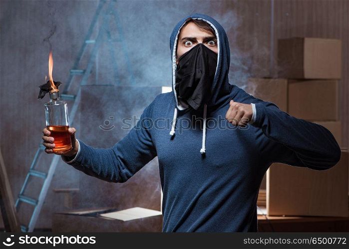 Rebel with molotov cocktail in dark room