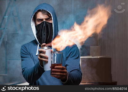 Rebel with molotov cocktail in dark room