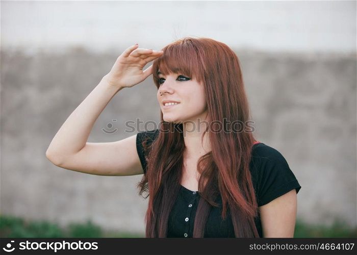 Rebellious teenager girl with red hair looking at side
