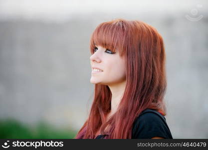 Rebellious teenager girl with red hair smiling