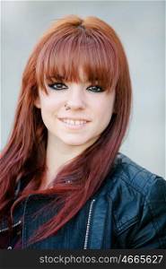 Rebellious teenager girl with red hair smiling