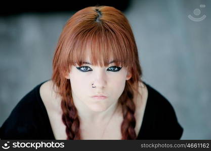 Rebellious teenager girl with red hair very angry view from above