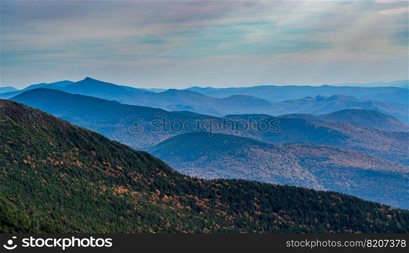 Receding summits of the Green Mountains to Camels Hump in the distance from Mount Mansfield. View from Mt Mansfield looking down Green Mountains